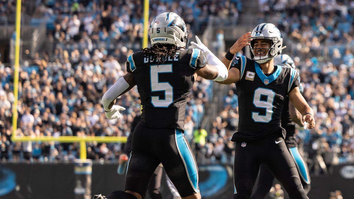 Carolina Panthers quarterback Bryce Young, right, celebrates a touchdown with Carolina Panthers running back Rico Dowdle at Bank of America Stadium in Charlotte, N.C., on Sunday, November 9, 2025.