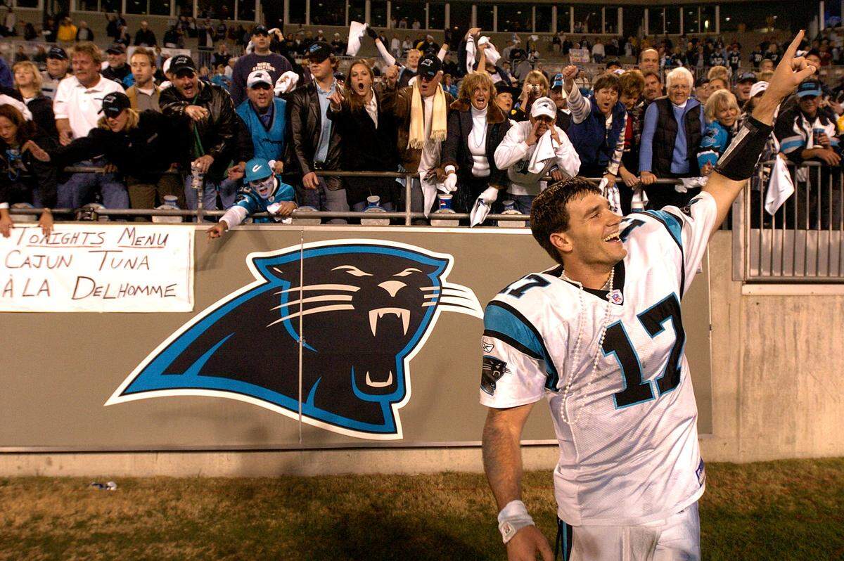 Carolina Panthers (17) quarterback Jake Delhomme raises his hand into the air after shaking hands with fans following the team's 29-10 playoff victory over the Dallas Cowboys on Jan. 3, 2004.