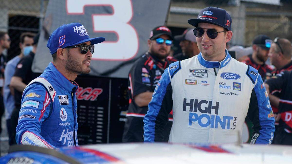 Kyle Larson, left, talks with Chase Briscoe before qualifications for the NASCAR Series auto race at Indianapolis Motor Speedway, Sunday, Aug. 15, 2021, in Indianapolis. (AP Photo/Darron Cummings)