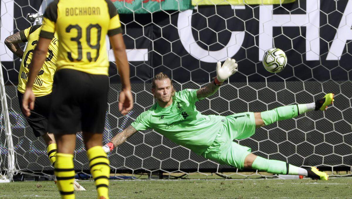 Liverpool's Loris Karius (1) can't stop a penalty kick by Borussia Dortmund's Christian Pulisic (22) during the second half of an International Champions Cup tournament soccer match in Charlotte, N.C., Sunday, July 22, 2018. (AP Photo/Chuck Burton)
