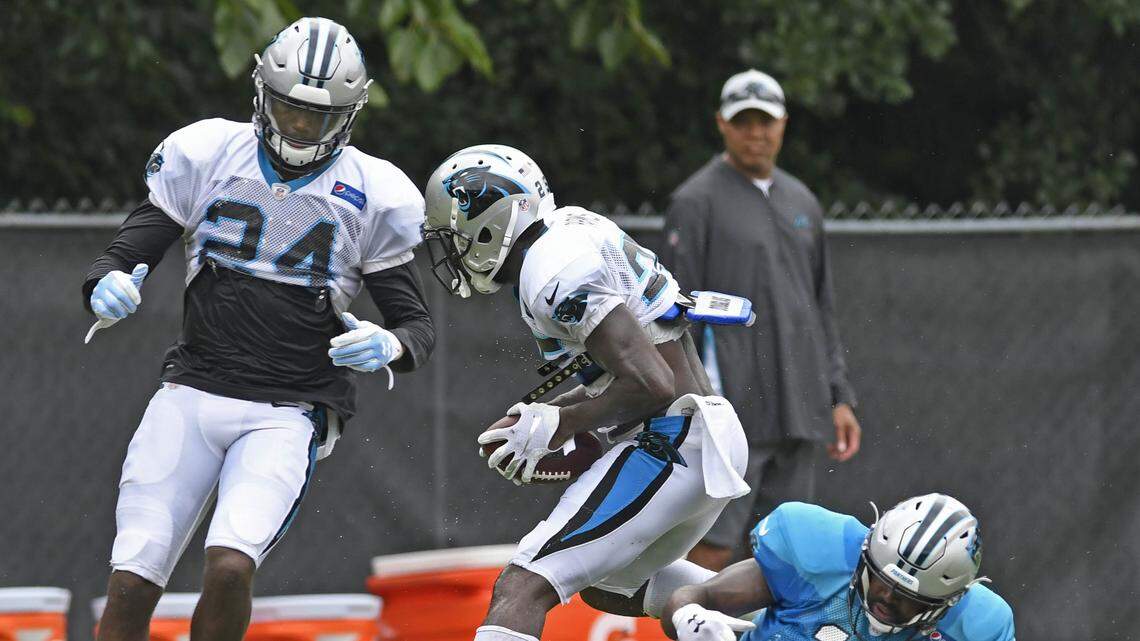 Carolina Panthers defensive back Damian Parms (25) intercepts a pass intended for wide receiver Torrey Smith (11), as cornerback James Bradberry (24) closes in, during practice at training camp at Wofford College in Spartanburg, SC on Thursday, August 2, 2018.