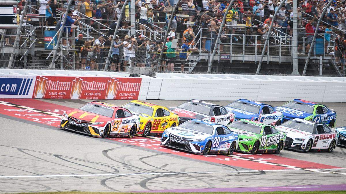 Aug 7, 2022; Brooklyn, Michigan, USA; NASCAR Cup Series driver Bubba Wallace (23) and driver Christopher Bell (20) lead the pack at the beginning of the race at Michigan International Speedway. Mandatory Credit: Tim Fuller-USA TODAY Sports