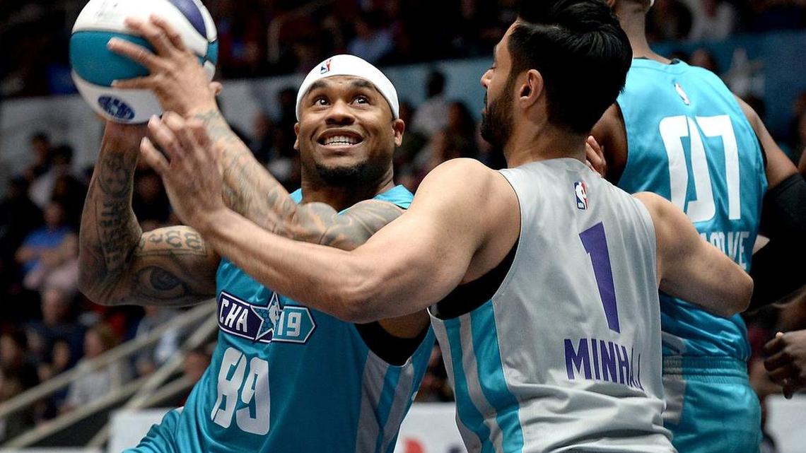 Former Carolina Panthers wide receiver Steve Smith, left, drives to the basket for a shot over comedian Hasan Minhaj during the NBA All-Star Celebrity Game at Bojangles' Coliseum on Friday.
