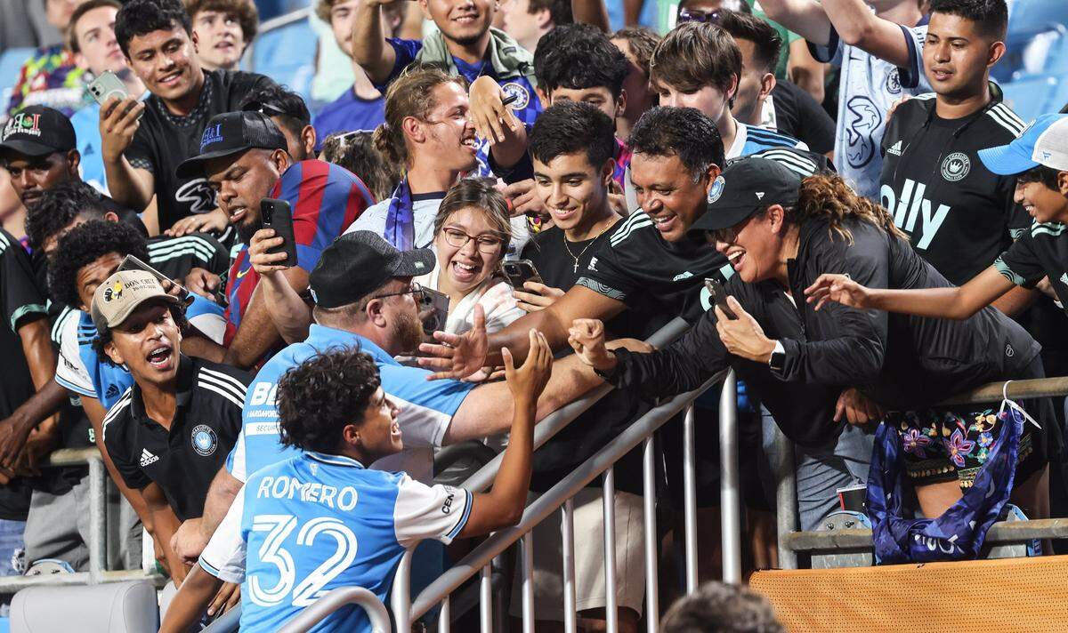 Charlotte FC Brian Romero, bottom left, celebrates with fans after a win against Chelsea at the Bank of America Stadium in Charlotte, N.C., on Wednesday, July 20, 2022. In many ways, he will be the face of Crown Legacy in the 2023 season.