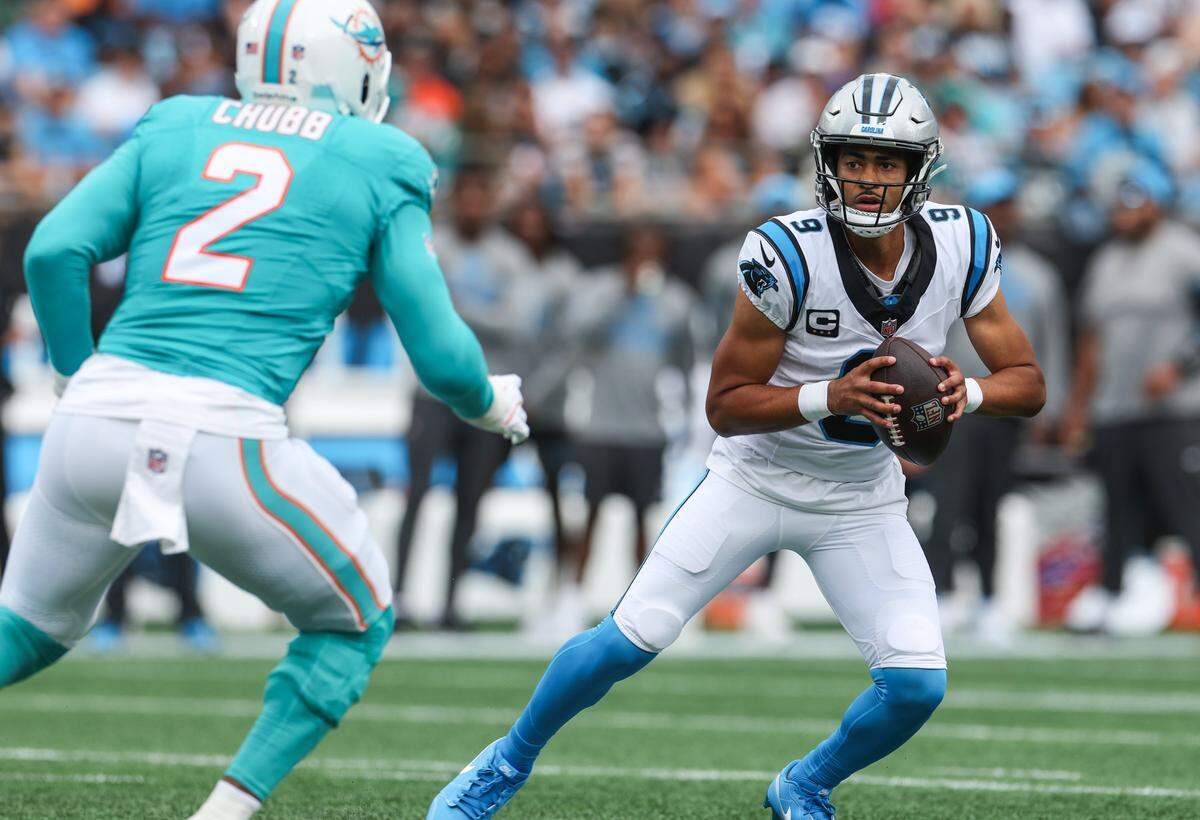 Panthers quarterback Bryce Young looks for a pass as Dolphins linebacker Bradley Chubb approaches during the game at Bank of America Stadium in Charlotte, NC on Sunday, October 5, 2025