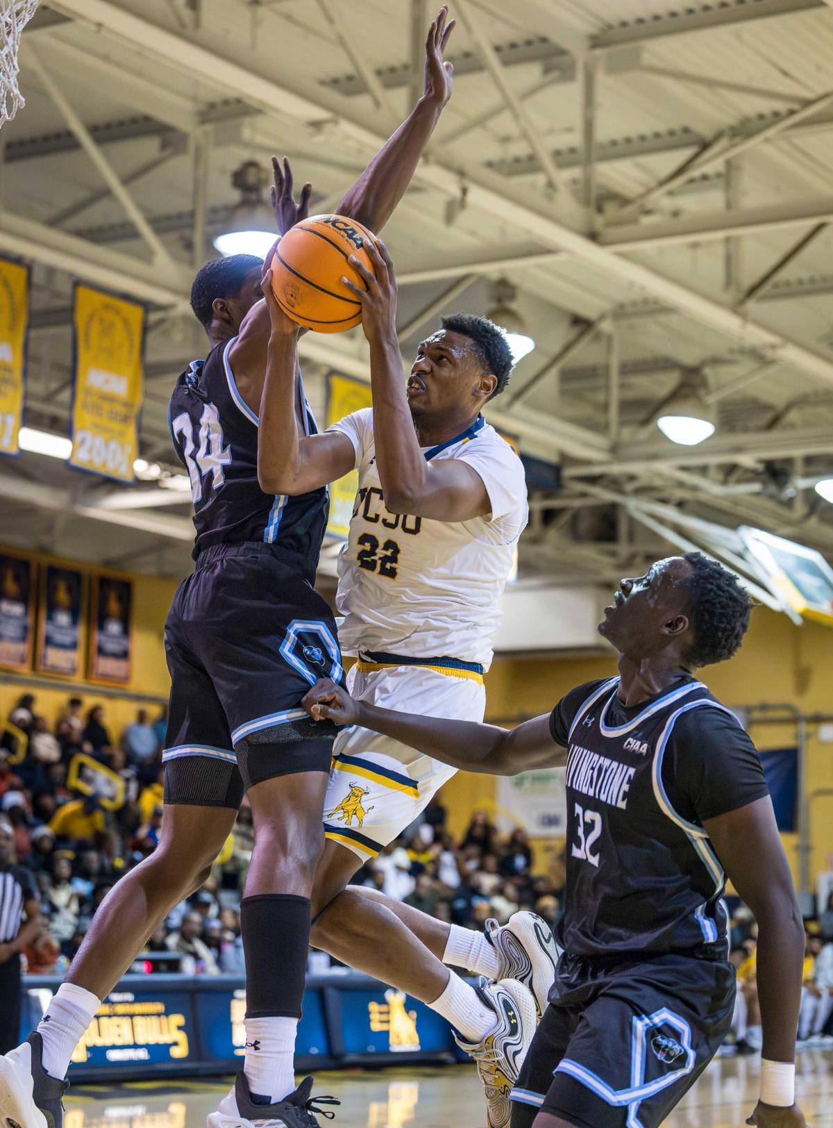 Johnson C. Smith senior forward Ashton Sherrell (22) drives the lane for the 2-point basket against Livingstone on Tuesday night. The Golden Bulls lost to their longtime rival in overtime.