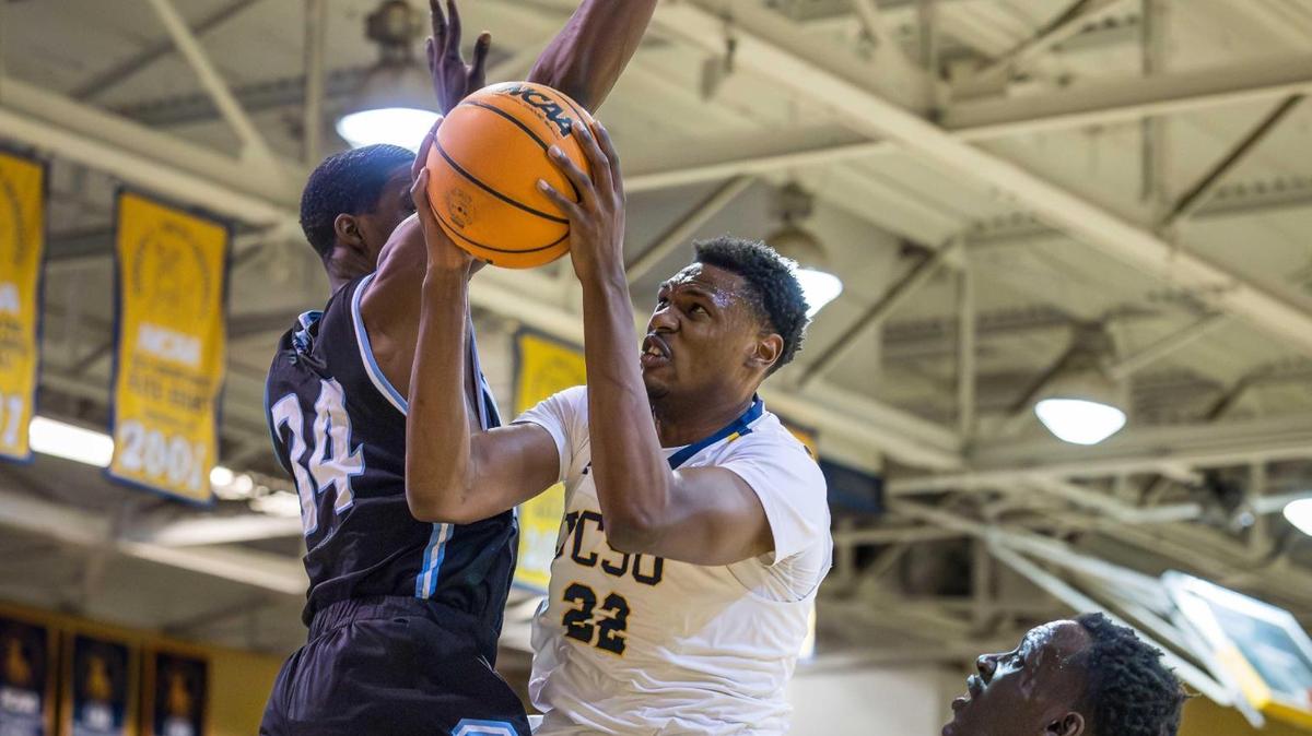 Johnson C. Smith senior forward Ashton Sherrell (22) drives the lane for the 2-point basket against Livingstone on Tuesday night. The Golden Bulls lost to their longtime rival in overtime.