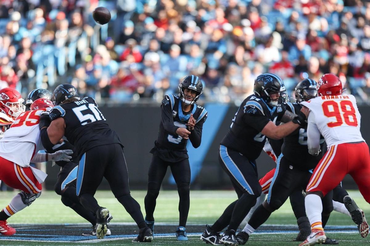Panthers quarterback Bryce Young, center, throws a pass as the offensive line creates a hole during the game against the Chiefs at Bank of America Stadium in Charlotte, NC on Sunday, Nov. 24, 2024.