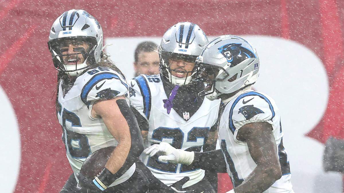 Carolina Panthers linebacker Christian Rozeboom, left, runs down the field with his teammates after intercepting a pass by Tampa Bay Buccaneers quarterback Baker Mayfield during action at Raymond James Stadium in Tampa, FL.on Saturday, January 3, 2026.