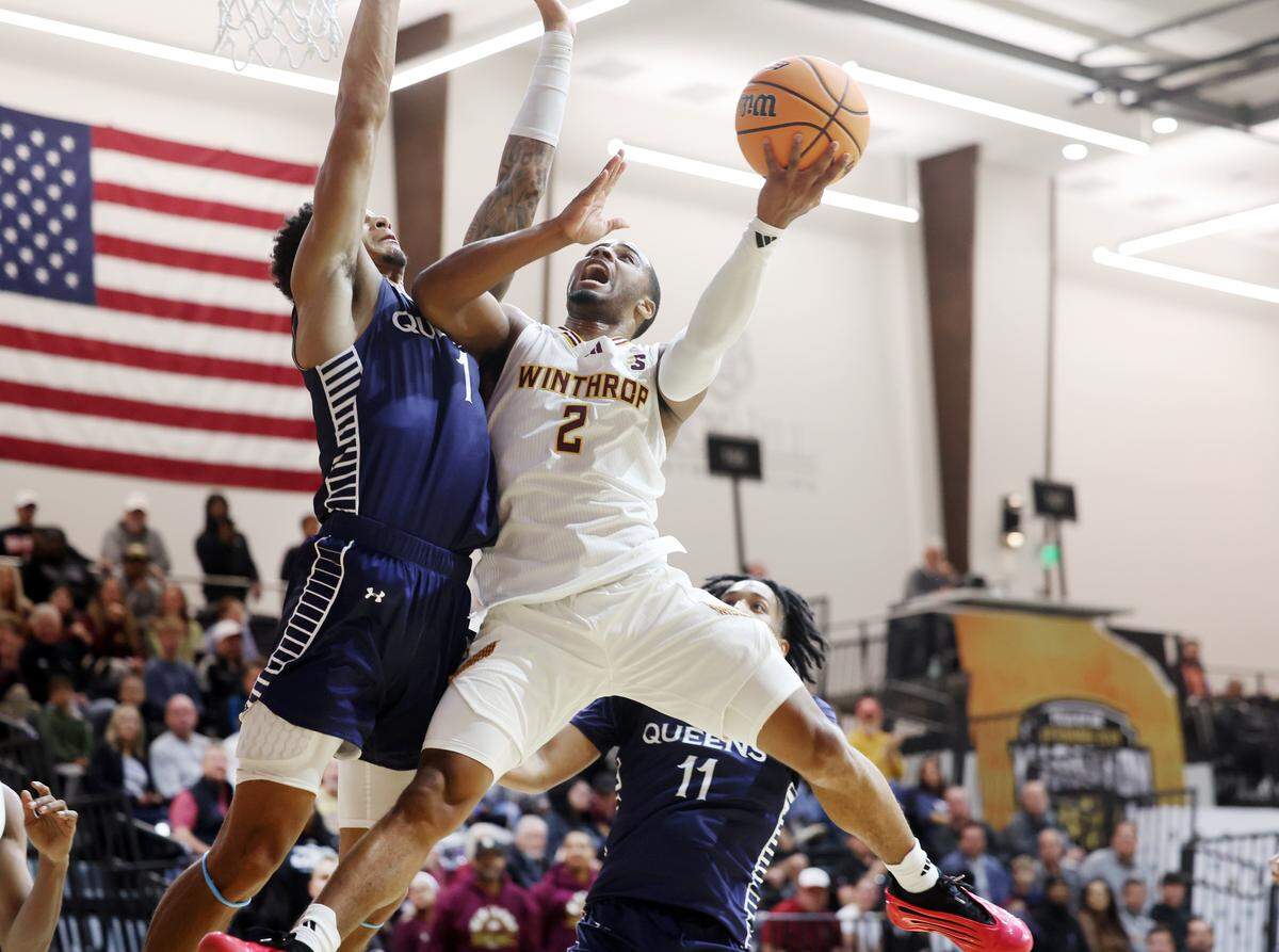 Winthrop University's Kareem Rozier (2) puts up the shot as Queens University's Jordan Watford tries to block it Monday, Nov. 3, 2025, at the Rock Hill Sports and Event Center.