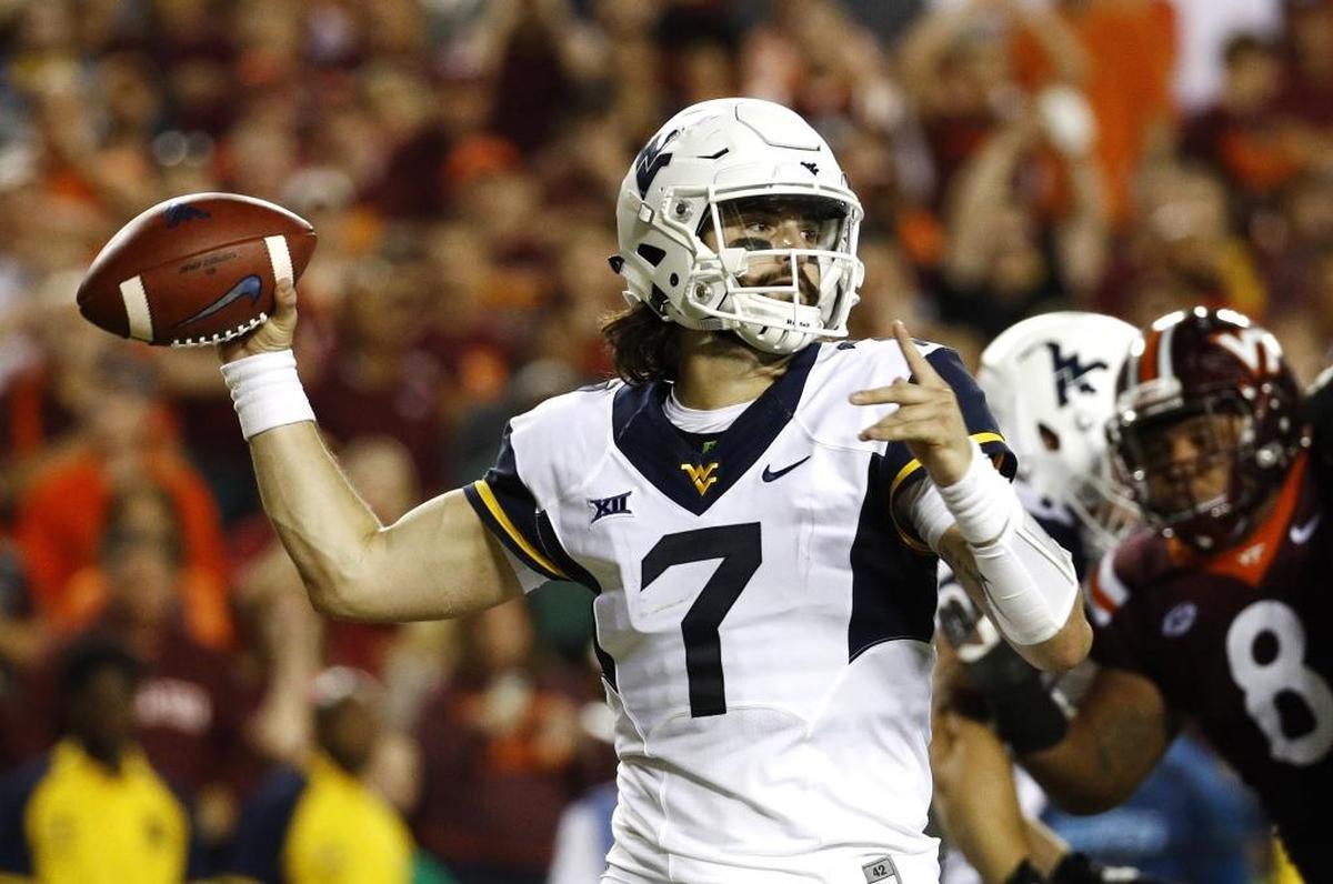 West Virginia quarterback Will Grier throws to a receiver in the first half of an NCAA college football game against Virginia Tech in Landover, Md., Sunday, Sept. 3, 2017. (AP Photo/Patrick Semansky)