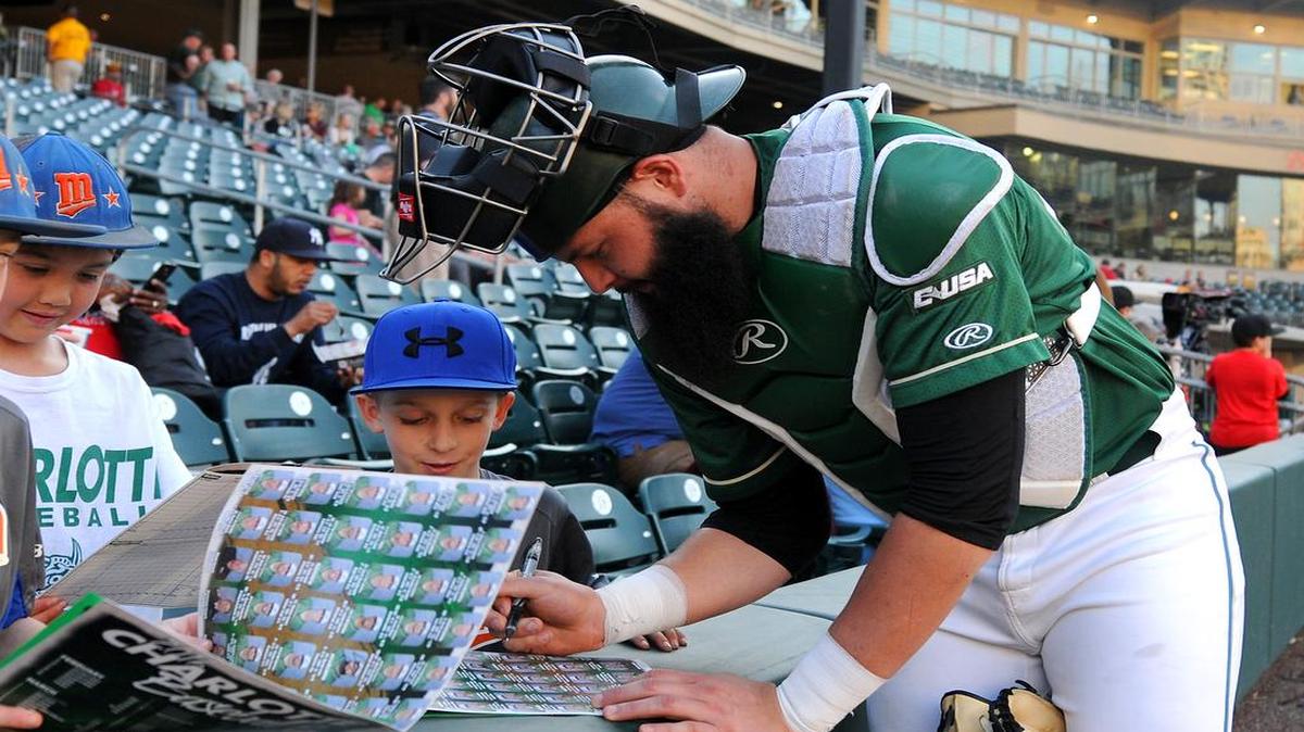 Charlotte 49ers catcher Derek Fritz signs autographs for young fans prior to action vs the Georgia Bulldogs in nonconference college baseball action on Tuesday, March 8, 2016 at BB&T BallPark in Charlotte, NC.