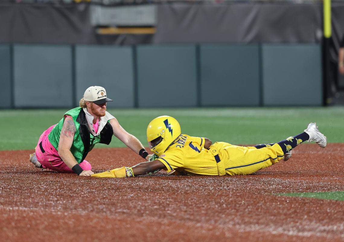 Bananas’ Malachi Mitchell slides into second base while Party Animals’ Dustin Baber tags him Friday, June 6, 2025 at Bank of America Stadium in Charlotte
