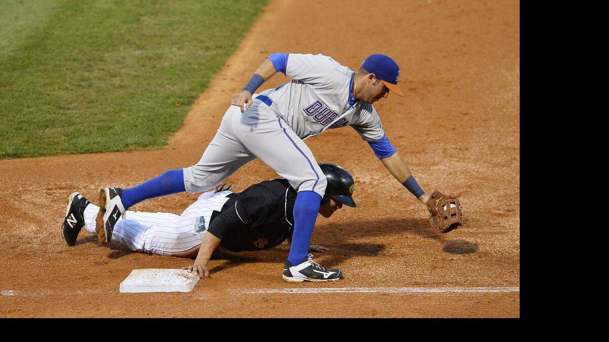 
 Charlotte Knights runner Tyler Saladino, on right, makes it back safe to first base on a steal attempt as Durham Bulls first baseman J.P. Arencibia reaches for the throw during Wednesday night's game against the Durham Bulls at BB&T Stadium.
