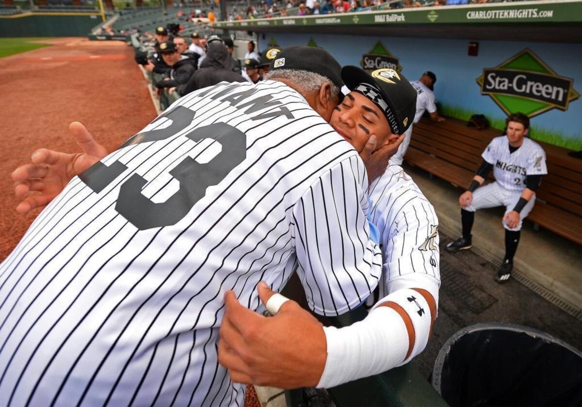 Former Major League Baseball great Luis Tiant, left, played an crucial role in his former club, the Boston Red Sox, signing second baseman Yoan Moncada, now with the Charlotte Knights, to a contract that included a record $31.5 million signing bonus in February 2015.
