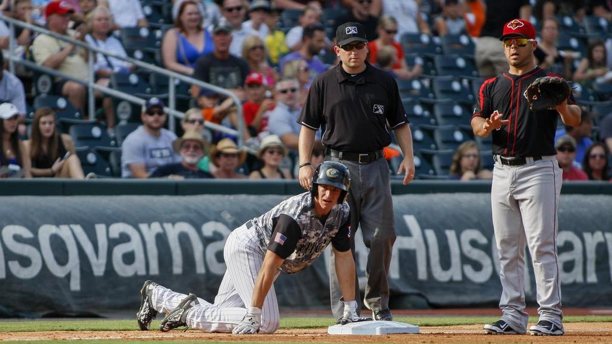 
Charlotte Knights designated hitter Rob Brantly, left, scrambles back to third base as Rochester Red Wings third baseman Jose Martinezlooks on Sunday. Brantly finished with three hits. 
