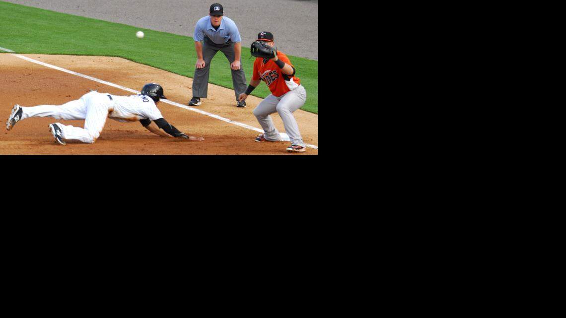 Charlotte Knights's Tyler Saladino dives back to first base during a pick-off attempt at the BB&T BallPark in Charlotte, on Thursday.
