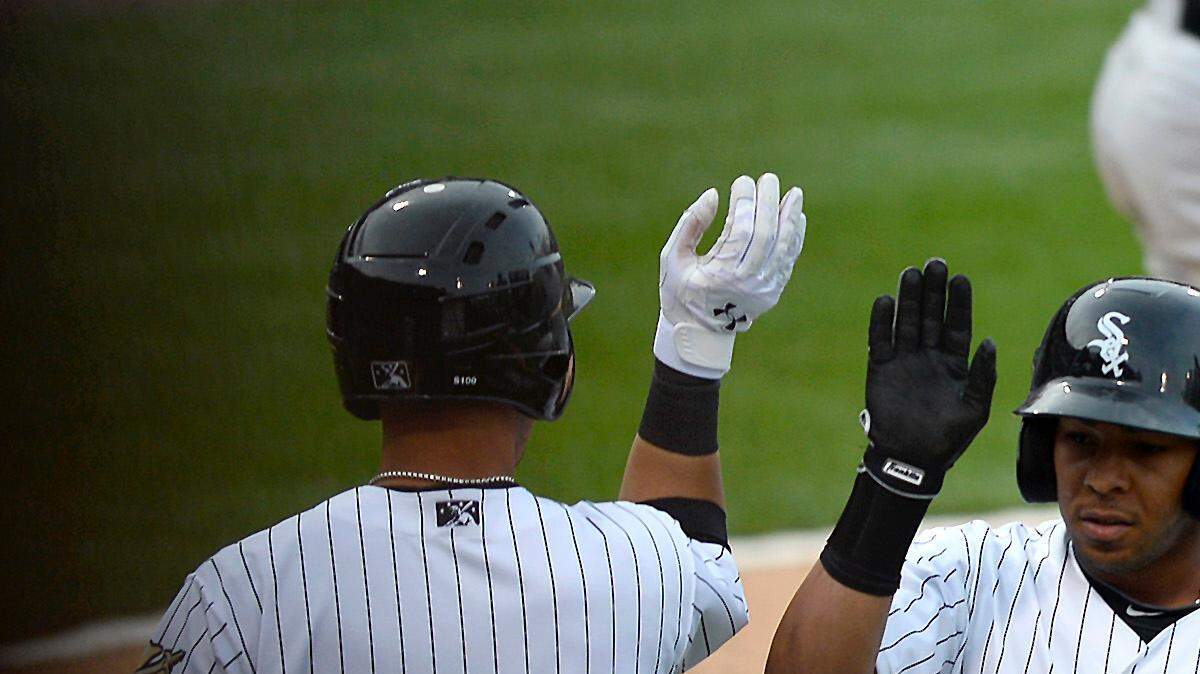 Neftali Soto, left, and Tyler Saladino, right, congratulate Leury Garcia, center, after his two-run homer Friday during an exhibition game against the Chicago White Sox at BB&amp;T BallPark in Charlotte.
