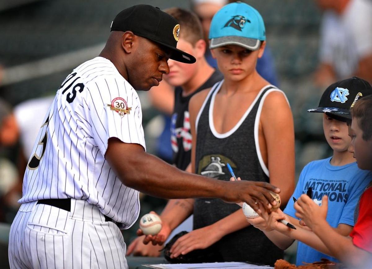 Charlotte Knights outfielder Jason Bourgeois signs autographs before a June game at BB&T Ballpark in uptown Charlotte.