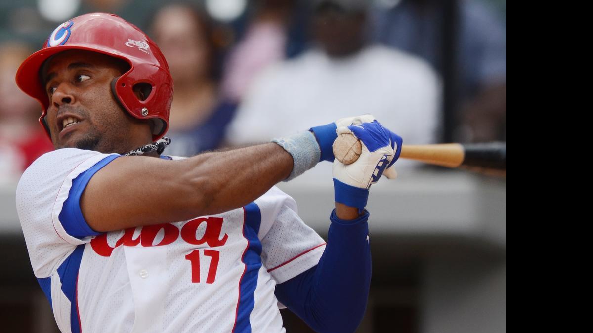 
Cuba's Urmany Guerra Vargas bats against the U.S. collegiate team during a baseball game in Charlotte on Saturday, July 4, 2015. 
