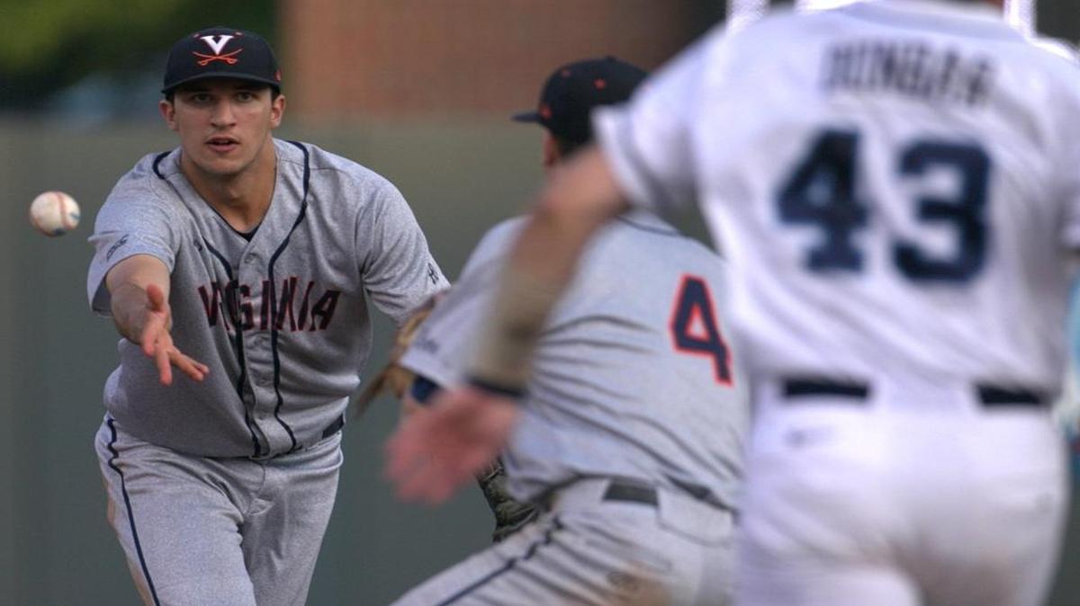 
Virginia short stop Daniel Pinero (22) tosses a fielded hit by North Carolina's Logan Warmoth to second baseman Ernie Clement (4) to force out Korney Dunbar (43) at second base in the second inning inning at Boshamer Staadium in Chapel Hill.
