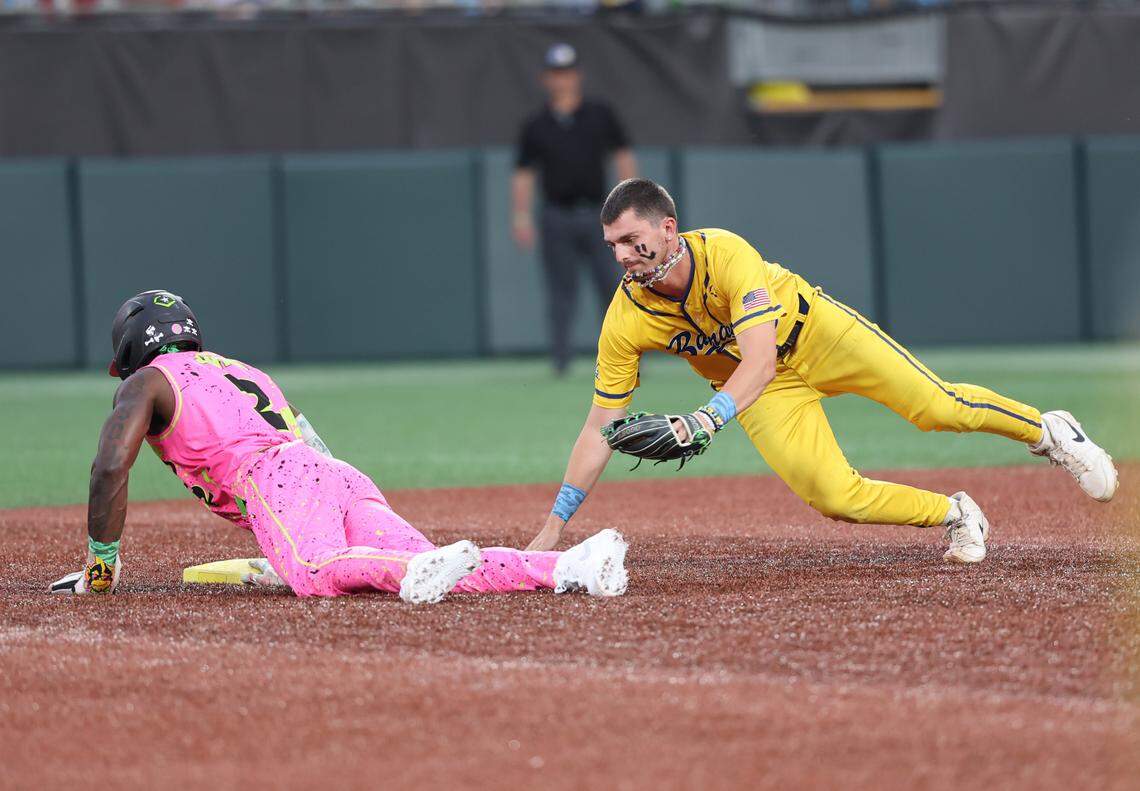 Party Animals’ Jason Swan slides back into second as Bananas’ Ryan Cox heads to the base Friday, June 6, 2025 at Bank of America Stadium in Charlotte.