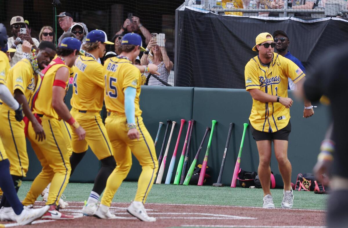 Carolina Panthers wide receiver Adam Thielen dances with the Savannah Bananas Saturday, June 7, 2025 during Banana Ball at Bank of America Stadium in Charlotte.