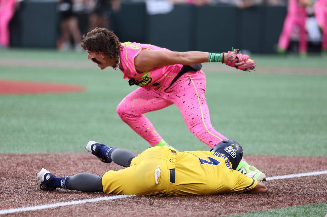 Bananas’ Ty Jackson slides into thrid base as Party Animals’ Bryson Bloomer looks to second base Friday, June 6, 2025 at Bank of America Stadium.