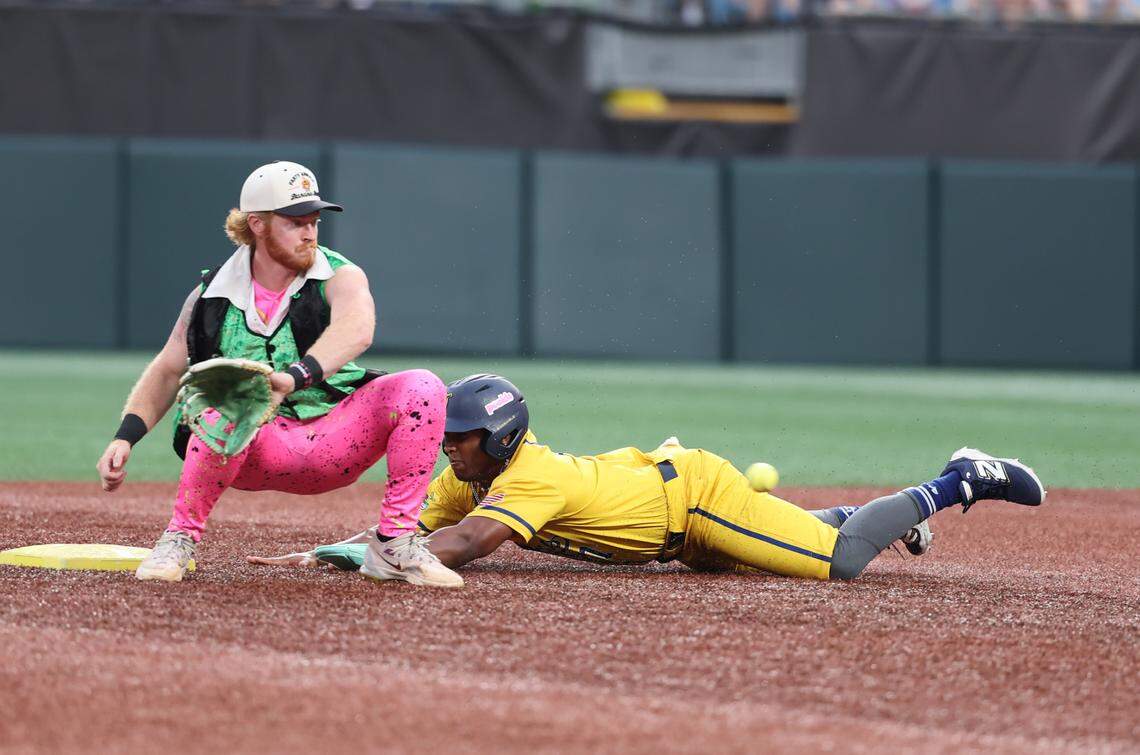 Bananas’ Ty Jackson slides into second base as Party Animals’ Dustin Baber waits for the ball Friday, June 6, 2025 at Bank of America Stadium in Charlotte.
