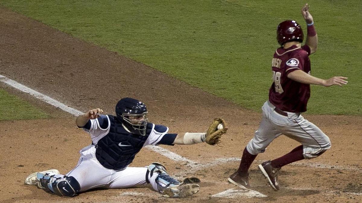 
Florida State’s Dylan Busby (28) scores on a double by Ben DeLuzio ahead of the tag by North Carolina catcher Korey Dunbar (43) in the third inning to give the Seminoles a 4-0 lead over the Tar Heels during the ACC Baseball Championship on Thursday, May 21, 2015 at the Durham Bulls Athletic Park in Durham, N.C.
