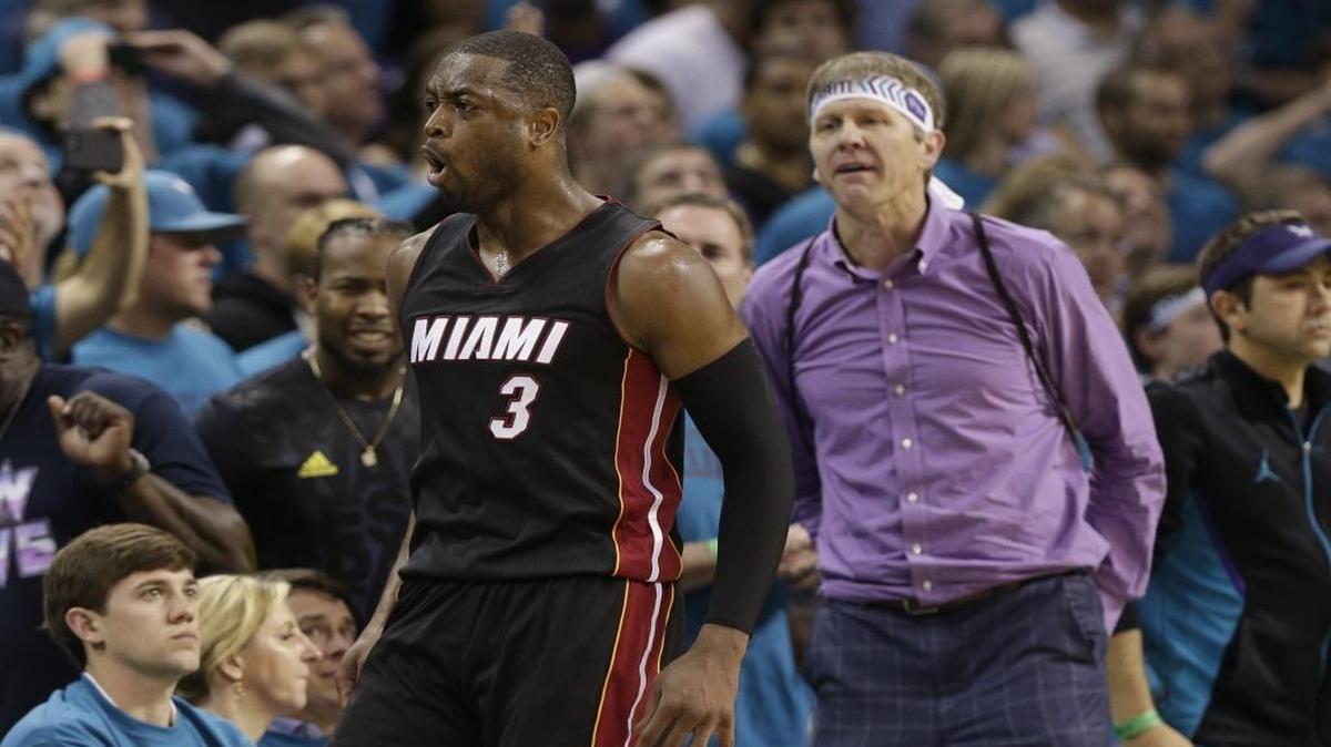 Miami Heat's Dwyane Wade, seen here being heckled by a Charlotte Hornets fan in Game 6 of last April’s NBA playoffs, is one of many athletes and celebs taking part in creating short rap videos for the #sogonechallenge that has gone viral on social media (AP Photo/Chuck Burton)