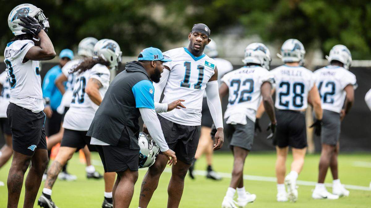Carolina Panthers Nic Scourton talks to a coach during the Carolina Panthers Rookie Minicamp in Charlotte, N.C., on Saturday, May 10, 2025.