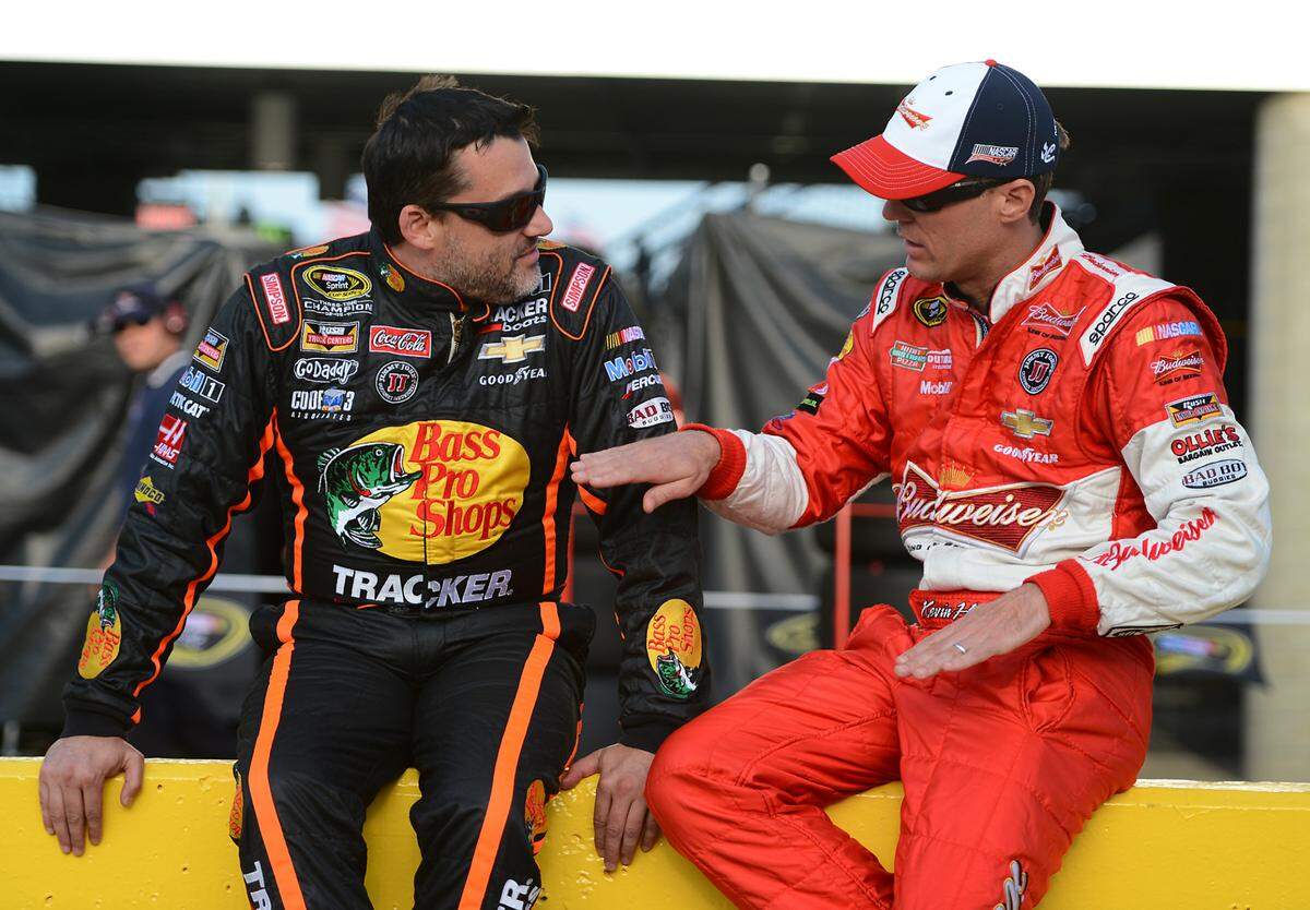 NASCAR Sprint Cup Series drivers Tony Stewart (14) and Kevin Harvick (4) talk along pit road prior to qualifying for the Coca-Cola 600 on Thursday, May 22, 2014 at Charlotte Motor Speedway.