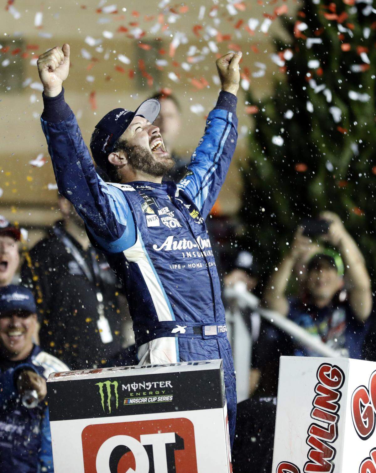 Martin Truex Jr. celebrates in Victory Lane after winning the NASCAR Monster Cup auto race at Kansas Speedway in Kansas City, Kan., Saturday, May 13, 2017. (AP Photo/Colin E. Braley)