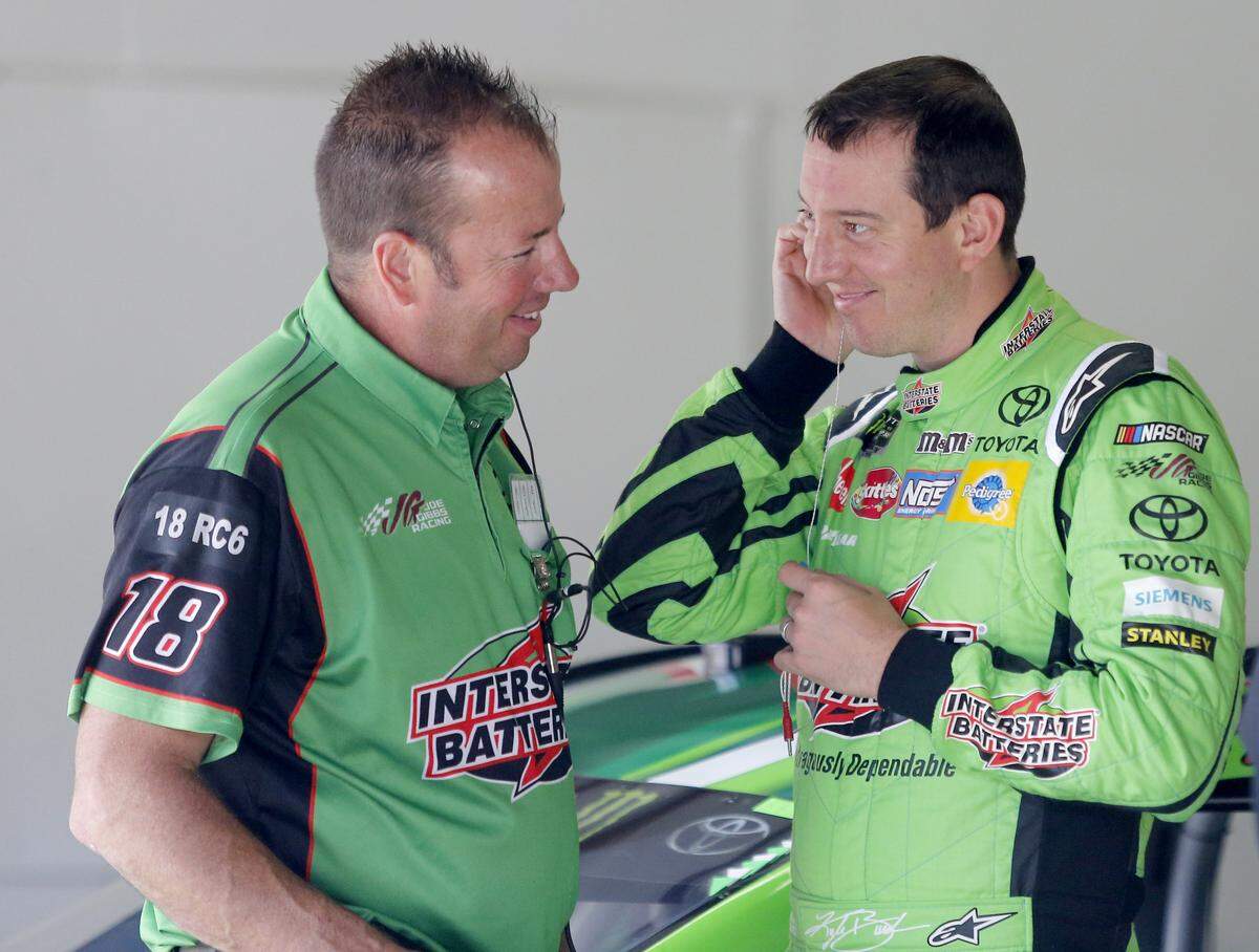 Kyle Busch smiles as he talks to a member of his crew during practice for the NASCAR Cup Series auto race Saturday, July 21, 2018, at New Hampshire Motor Speedway in Loudon, N.H. (AP Photo/Mary Schwalm)