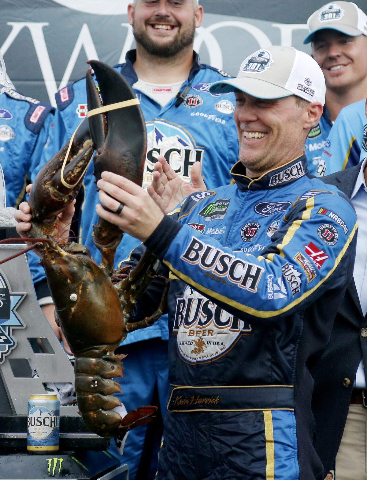 Kevin Harvick smiles as he holds up a large lobster in Victory Lane after winning the NASCAR Cup Series auto race Sunday, July 22, 2018, at New Hampshire Motor Speedway in Loudon, N.H. (AP Photo/Mary Schwalm)