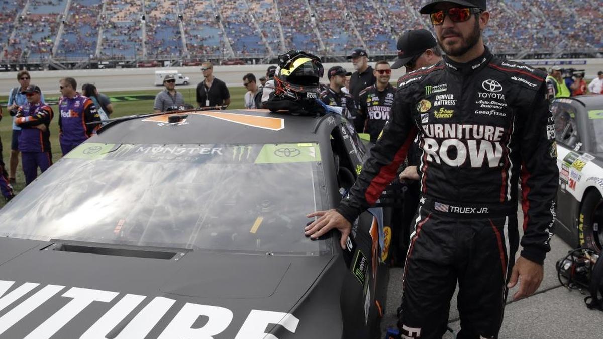 Martin Truex Jr., shown in a file photo, won the pole for Sunday’s playoff cutdown race at Dover by besting Kyle Busch in qualifying.