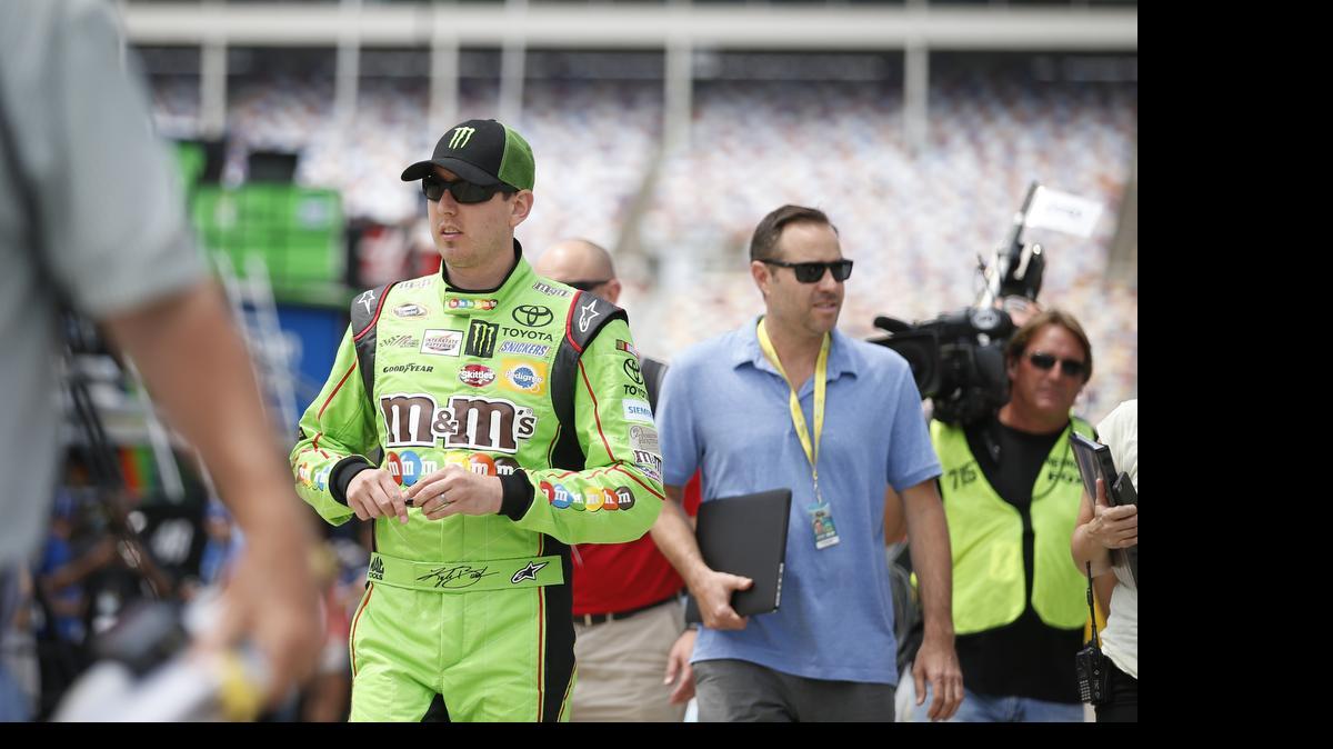 
Kyle Busch walks to the garage area for practice for the NASCAR Sprint All-Star Race in Concord on Friday. Busch posted the day’s top practice speed, 188.884 mph. 
