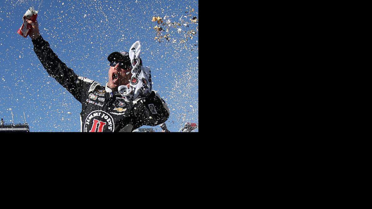 
Kevin Harvick celebrates in victory lane after winning the NASCAR Sprint Cup Series CampingWorld.com 500 at Phoenix International Raceway on Sunday, March 15, 2015 in Avondale, Ariz.
