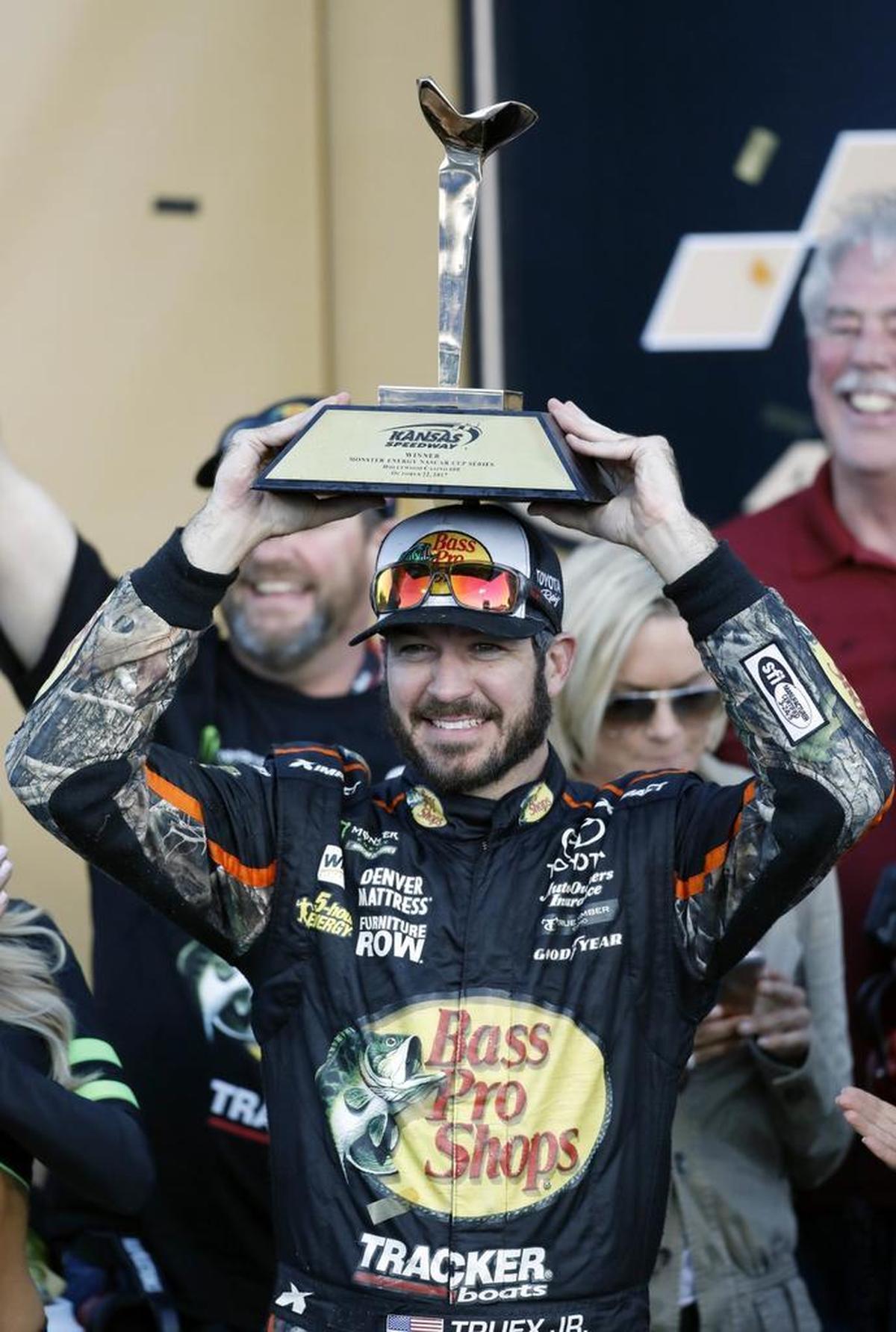 Martin Truex Jr. celebrates winning Sunday’s NASCAR Cup Series auto race at Kansas Speedway in Kansas City, Kan.
