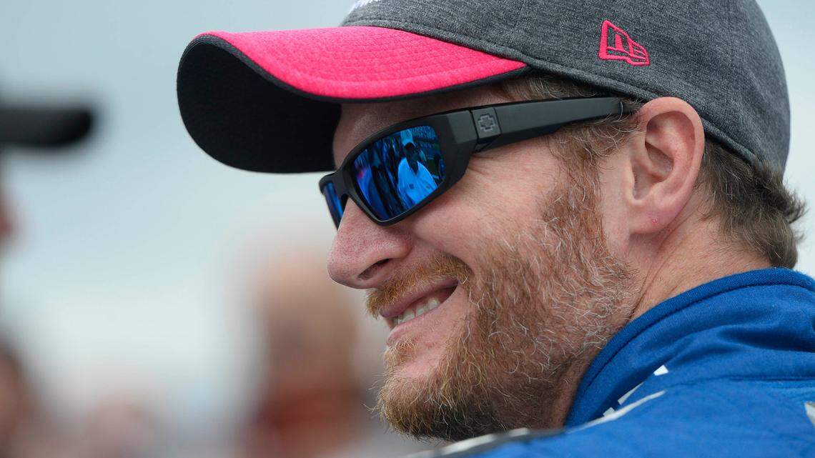 NASCAR driver Dale Earnhardt Jr smiles as he talks with team owner Rick Hendrick prior to the start of the Bank of America 500 at Charlotte Motor Speedway on Sunday, October 8, 2017.
