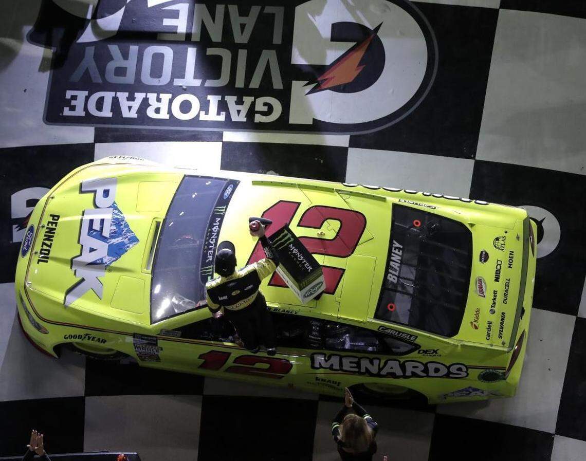 Ryan Blaney celebrates on his car after winning the first of Thursday’s two qualifying auto races for the Daytona 500 at Daytona International Speedway.