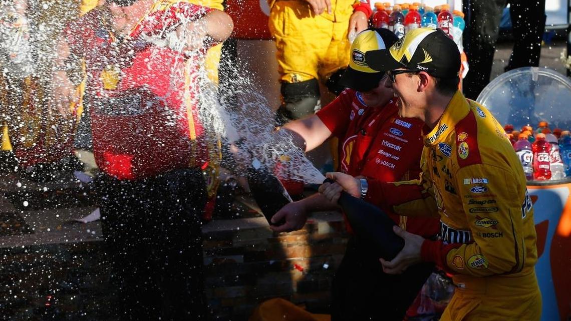 Joey Logano celebrates after winning Sunday’s NASCAR Sprint Cup Series race at Phoenix International Raceway.