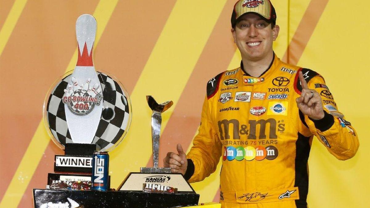Kyle Busch, driver of the #18 M&M's Red Nose Toyota, poses for a photo in Victory Lane after the NASCAR Sprint Cup Series Go Bowling 400 at Kansas Speedway on May 7, 2016 in Kansas City, Kansas.