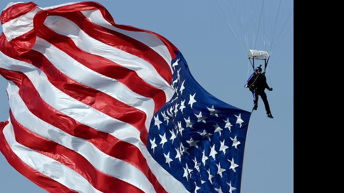 
A parachutist brings a large American flag into the infield area at Charlotte Motor Speedway on Sunday, May 24, 2015, prior to the running of the Coca-Cola 600.
