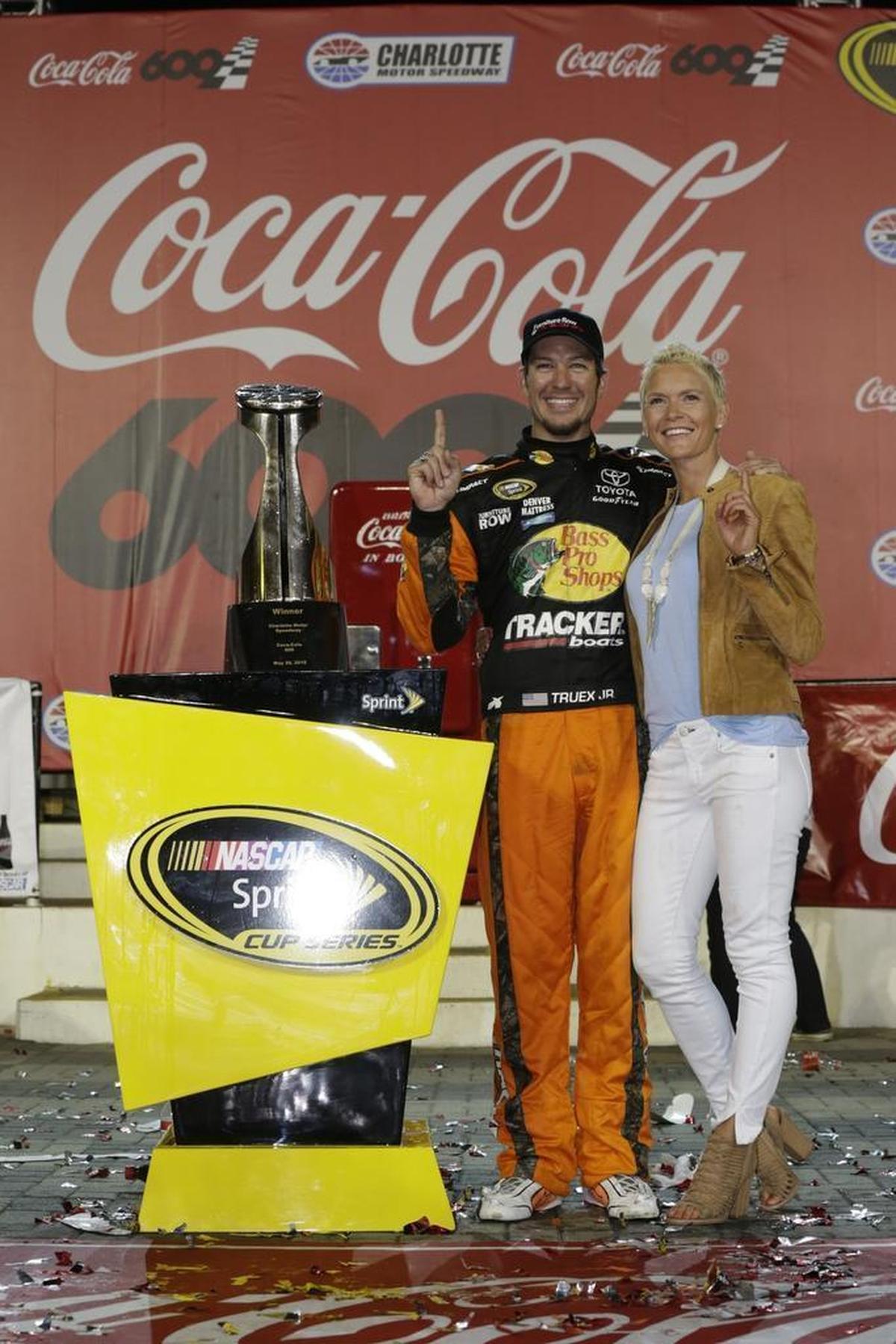 Martin Truex Jr. and girlfriend Sherry Pollex celebrate in Victory Lane at Charlotte Motor Speedway after Truex won the 2016 Coca-Cola 600.