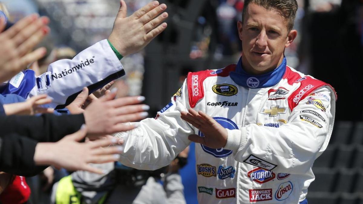 Sprint Cup Series driver AJ Allmendinger greets fans during driver introductions for the Sprint Cup auto race at Martinsville Speedway Sunday.
