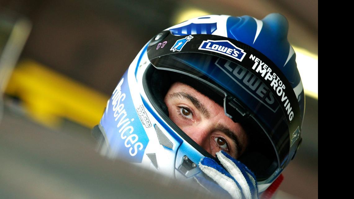 
Jimmie Johnson climbs into his car in the garage area during practice for the NASCAR Sprint Cup Series FedEx 400 Benefiting Autism Speaks at Dover International Speedway on Friday, May 29, 2015 in Dover, Del. 
