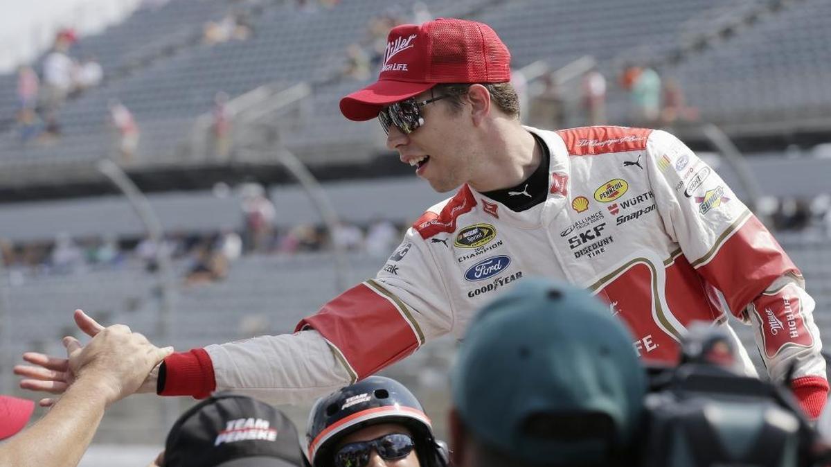 
Brad Keselowski is congratulated by crew members after winning the pole for Sunday’s NASCAR Sprint Cup auto race at Darlington Raceway in Darlington, S.C., Saturday. 
