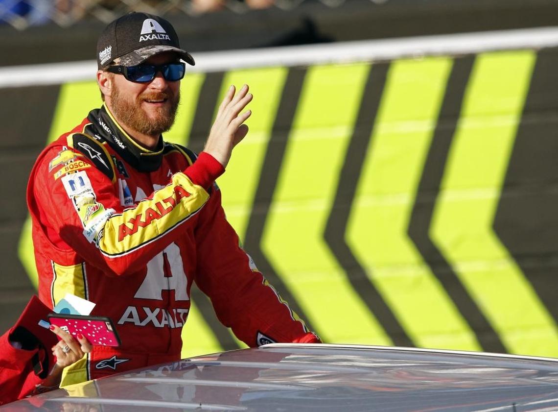 Dale Earnhardt Jr. waves to fans as he makes his way around the track at Bristol Motor Speedway before Saturday’s NASCAR Cup Series auto race in Bristol, Tenn.